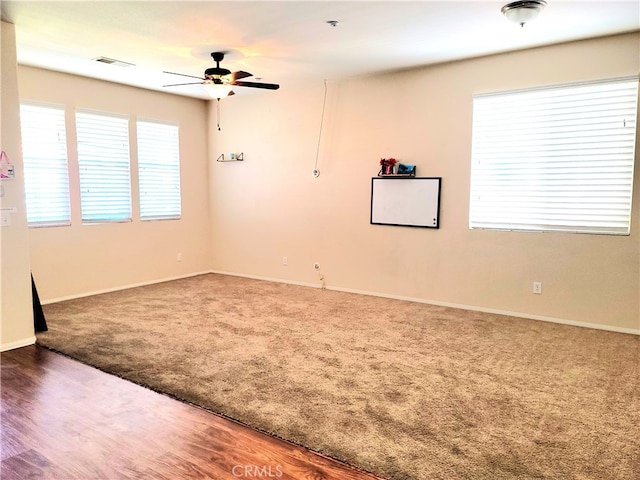 spare room featuring carpet and ceiling fan