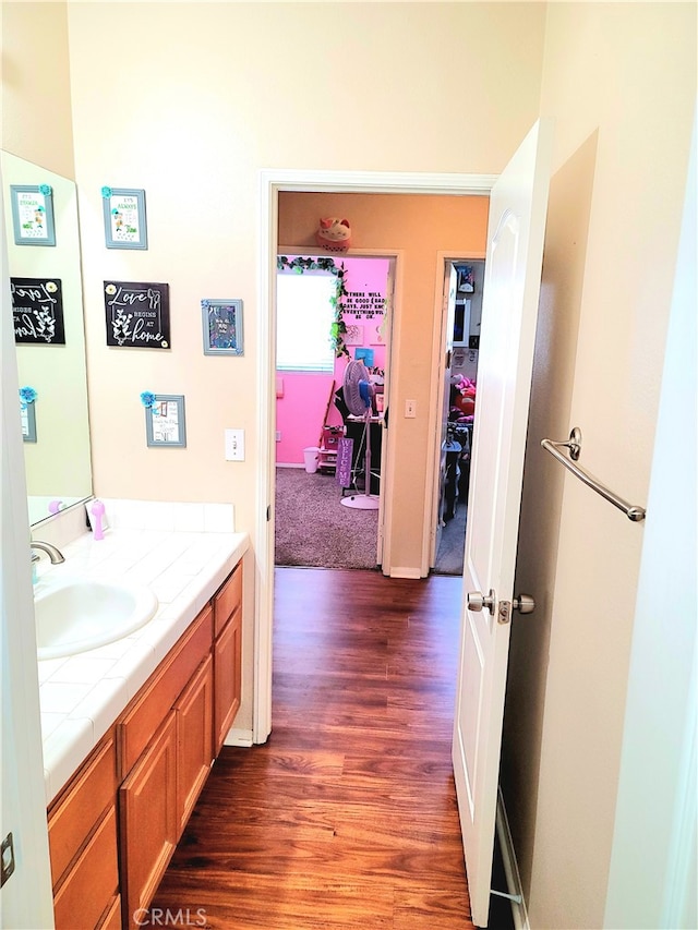 bathroom with hardwood / wood-style flooring and vanity