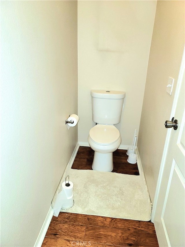 bathroom with hardwood / wood-style floors and toilet