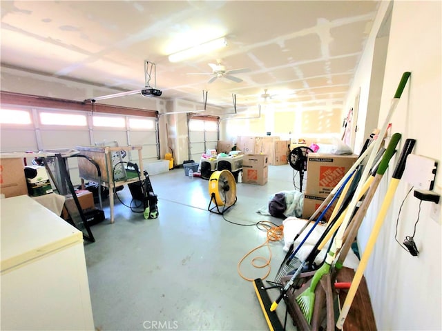 garage with a garage door opener and ceiling fan