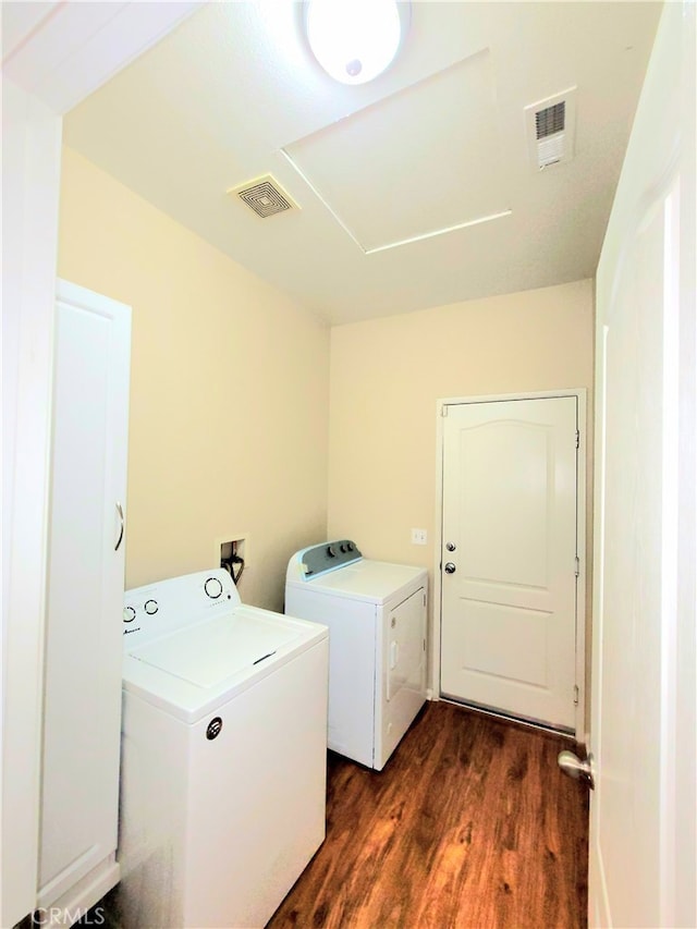 laundry room featuring separate washer and dryer and dark hardwood / wood-style flooring