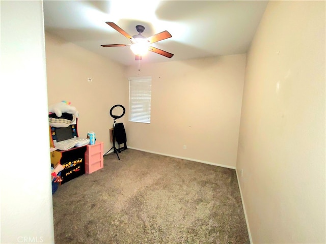 exercise room with carpet floors and ceiling fan