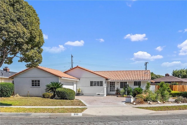 ranch-style home featuring a garage and a front yard