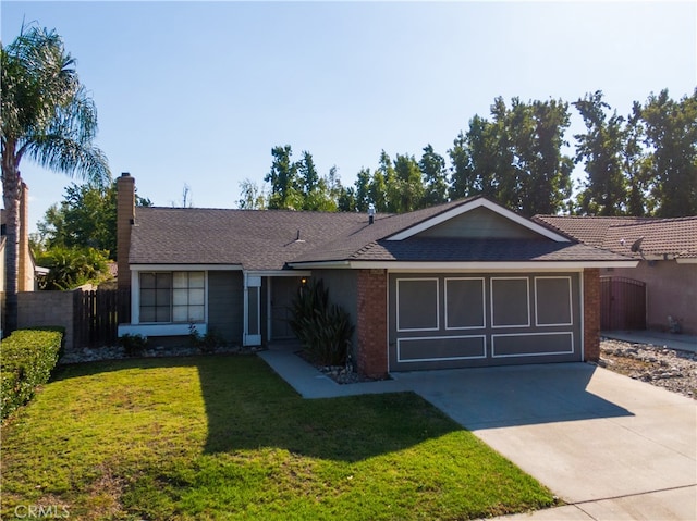 ranch-style house featuring a front yard and a garage