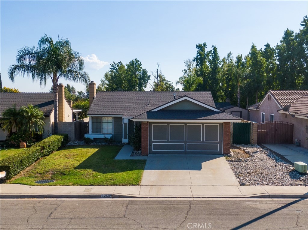 ranch-style home featuring a front yard and a garage