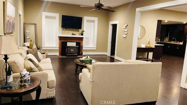 living room featuring ceiling fan, sink, and dark wood-type flooring