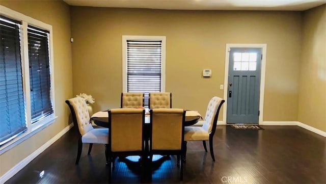 dining space with dark wood-type flooring