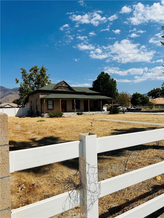 view of front of house with a mountain view and a porch