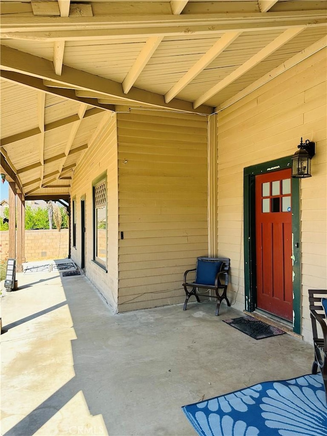 view of exterior entry featuring a patio area