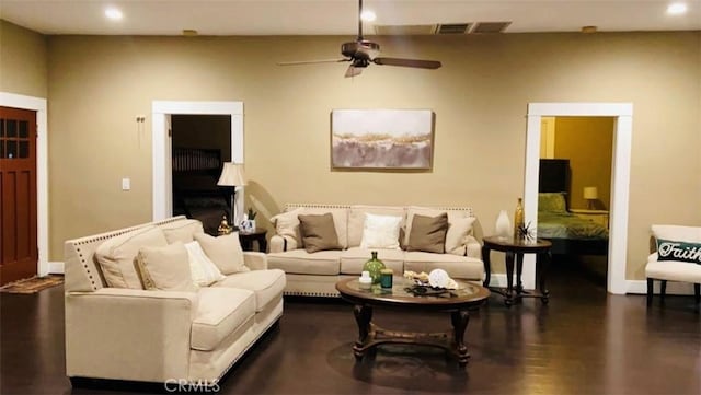 living room with ceiling fan and dark hardwood / wood-style flooring