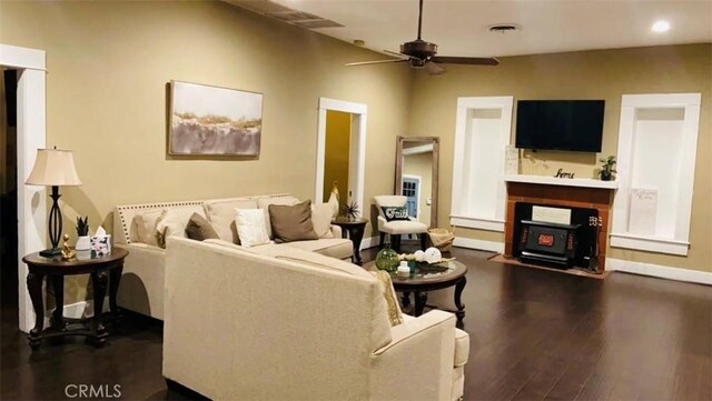 living room featuring ceiling fan and dark hardwood / wood-style flooring