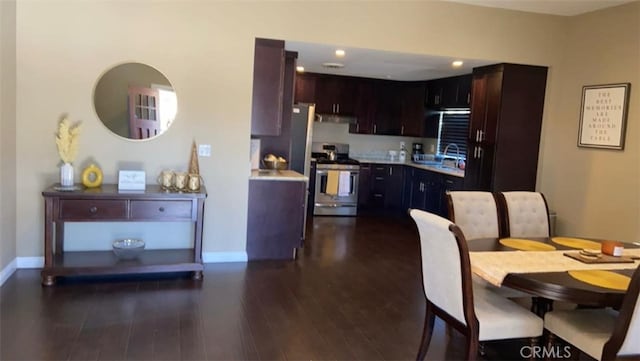 kitchen featuring dark brown cabinetry, stainless steel range, dark hardwood / wood-style floors, and sink