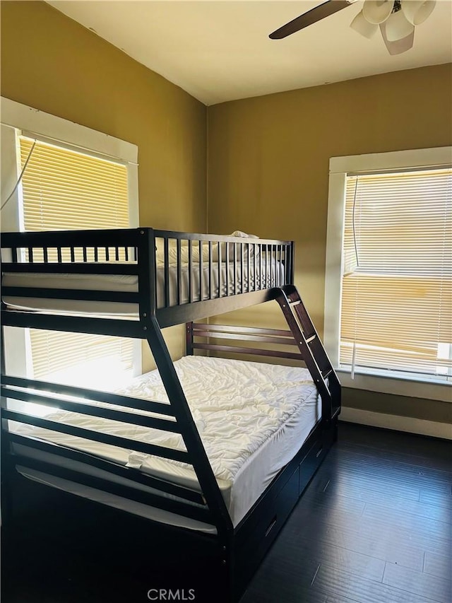 bedroom featuring ceiling fan and dark wood-type flooring