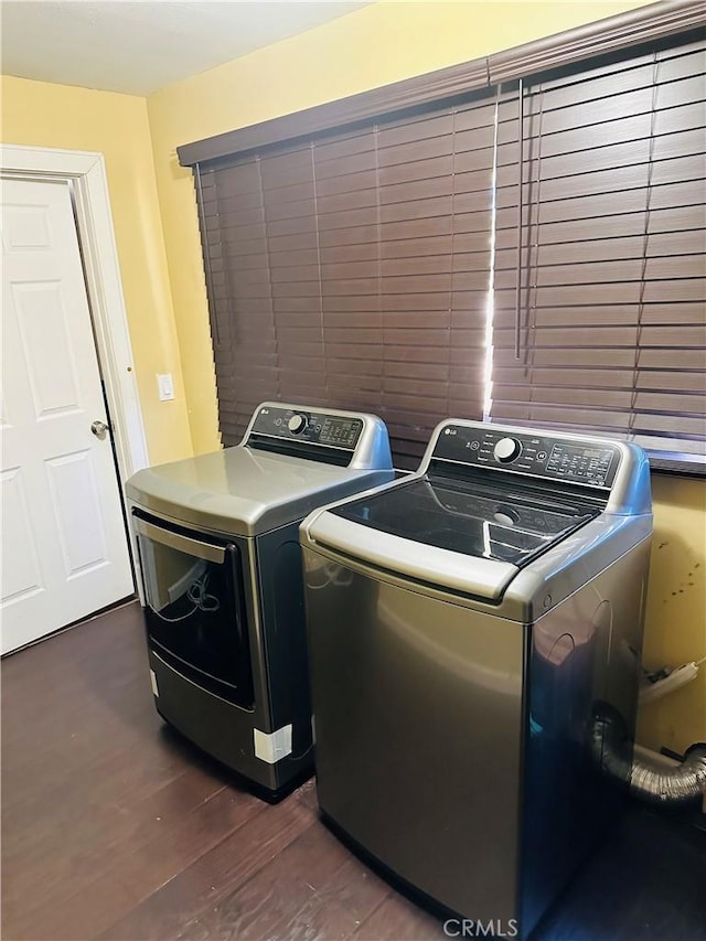 laundry area featuring dark hardwood / wood-style flooring and washing machine and dryer