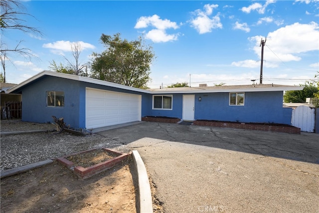 ranch-style house featuring a garage