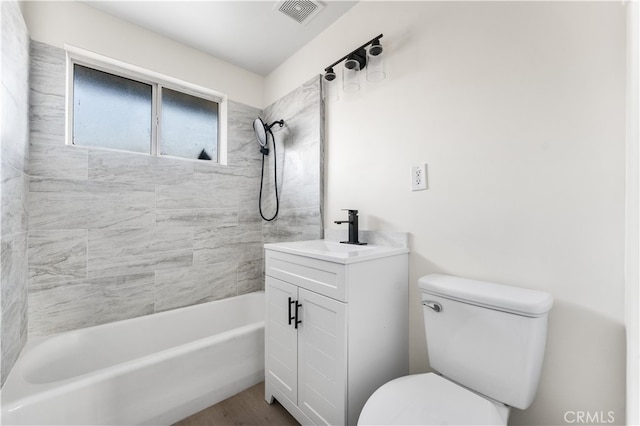 full bathroom featuring vanity, toilet, and tiled shower / bath