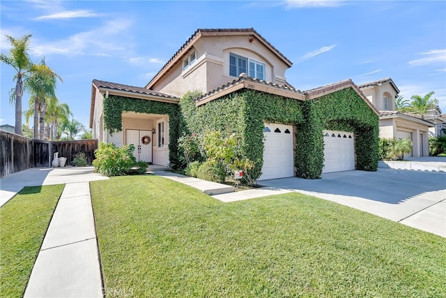 mediterranean / spanish-style home featuring a garage and a front lawn