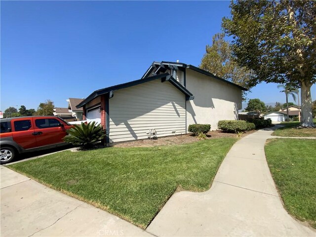 view of home's exterior with a lawn