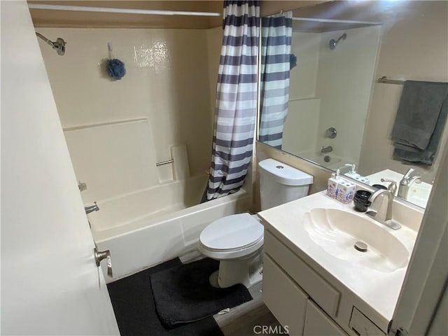 bathroom with toilet, shower / tub combo, and vanity