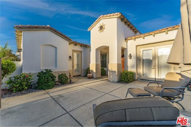 rear view of property featuring a patio area