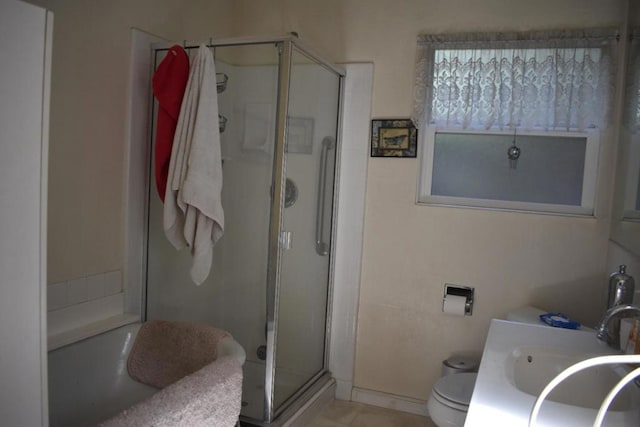 bathroom with a shower with door, toilet, and vanity