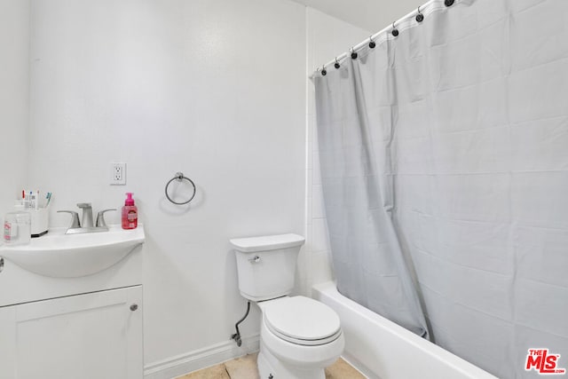 full bathroom featuring tile patterned flooring, shower / bath combination with curtain, toilet, and vanity