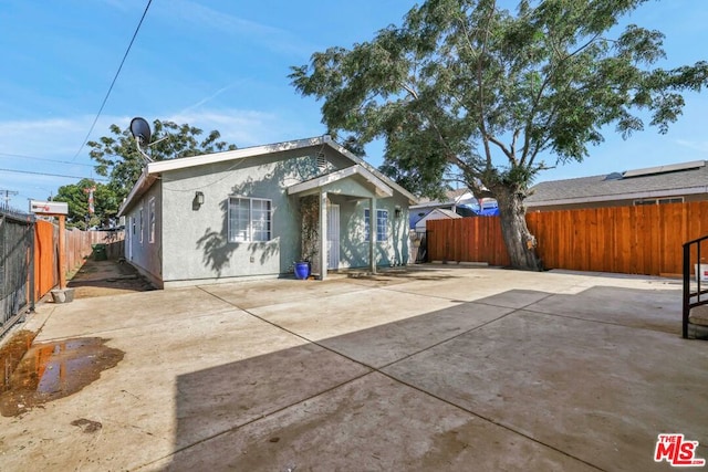 back of property featuring a patio area