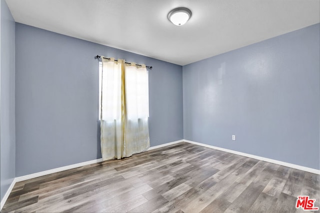 unfurnished room featuring hardwood / wood-style floors