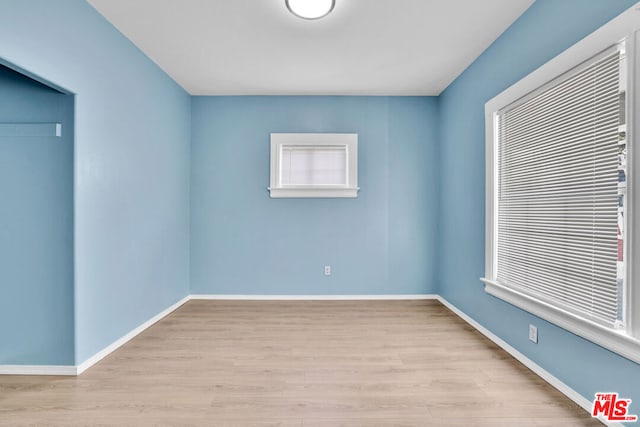 empty room with light hardwood / wood-style flooring