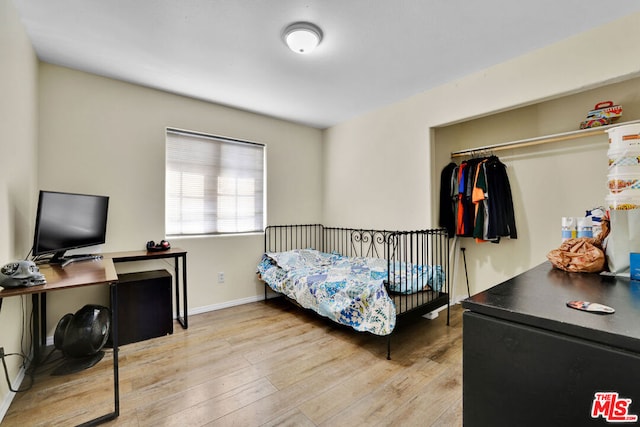 bedroom featuring a closet and light hardwood / wood-style floors