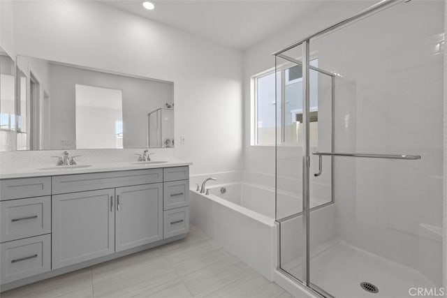9665 Larimar Ct, Riverside, CA 92508 - bathroom featuring double vanity, a bath, a shower stall, and a sink