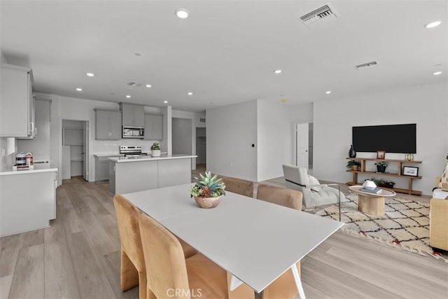 9665 Larimar Ct, Riverside, CA 92508 - dining area with visible vents, light wood-style flooring, and recessed lighting