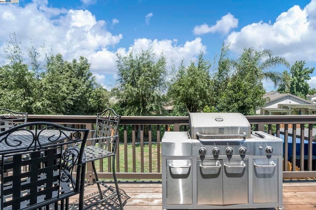 wooden deck featuring an outdoor kitchen and area for grilling