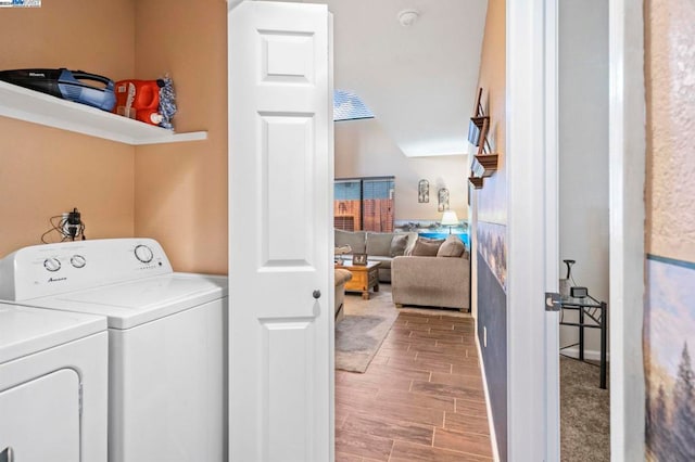 washroom featuring wood-type flooring and washing machine and dryer