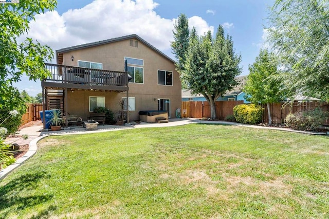 rear view of property with a deck, a yard, and a patio area