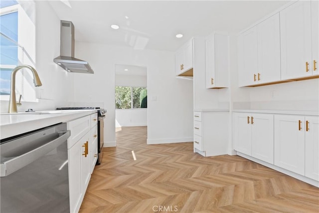 kitchen with dishwasher, white cabinets, and wall chimney range hood