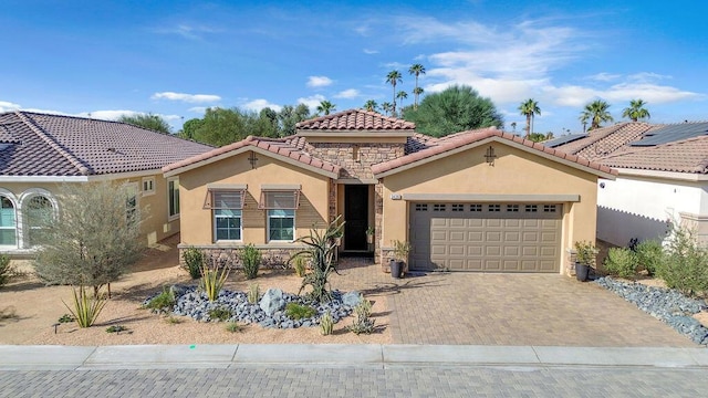 mediterranean / spanish-style house with a garage