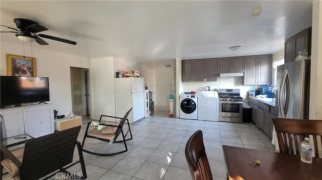 kitchen featuring ceiling fan, washer and clothes dryer, dark brown cabinetry, appliances with stainless steel finishes, and light tile patterned floors