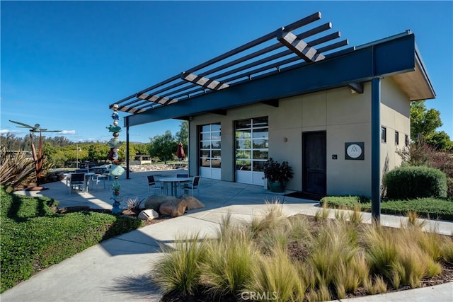 exterior space with a patio and a pergola