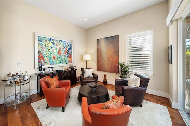 living area with hardwood / wood-style flooring and plenty of natural light