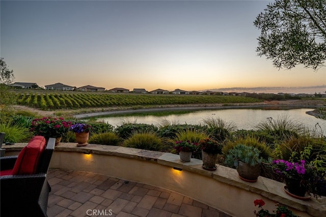 patio terrace at dusk with a water view