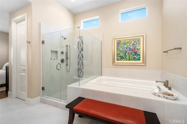 bathroom with tile patterned flooring and separate shower and tub