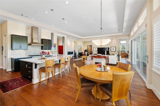 dining room featuring hardwood / wood-style flooring and a raised ceiling