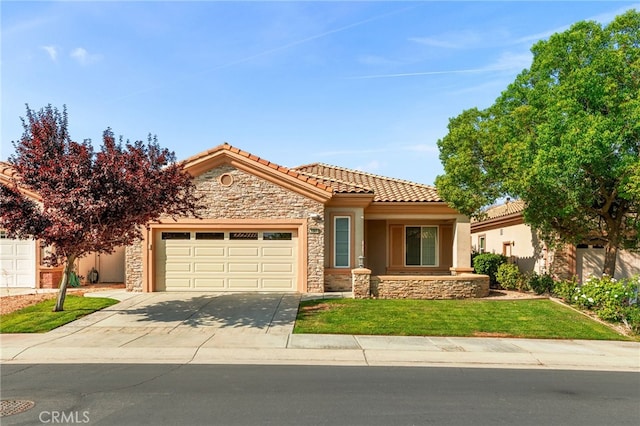 view of front of home with a front yard and a garage