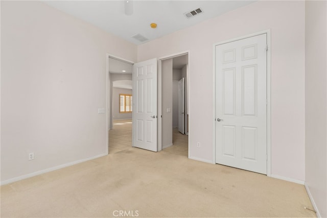 unfurnished bedroom featuring light colored carpet