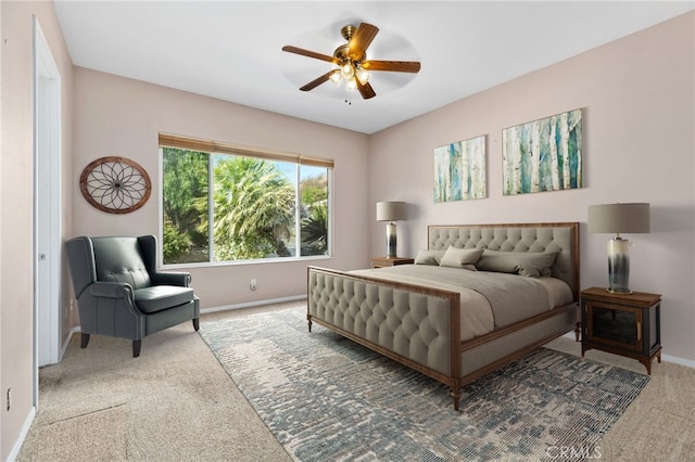 carpeted bedroom featuring baseboards and ceiling fan
