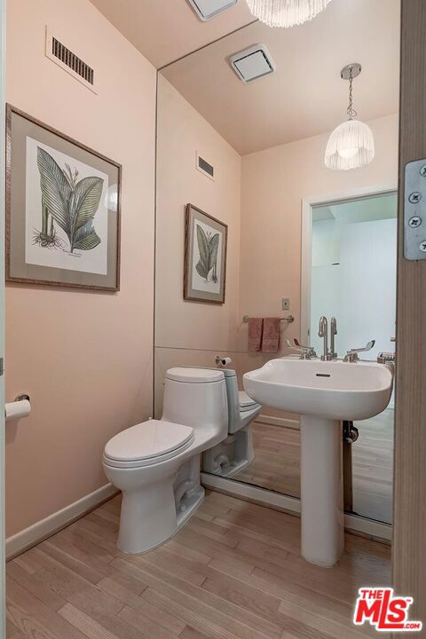 bathroom featuring toilet and hardwood / wood-style flooring