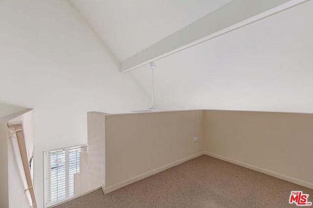 interior space featuring carpet flooring, beam ceiling, and high vaulted ceiling