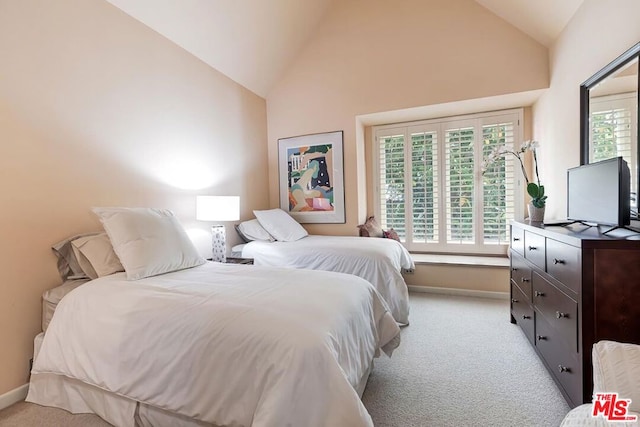 carpeted bedroom featuring high vaulted ceiling