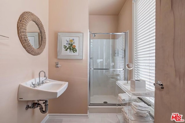 bathroom featuring tile patterned flooring and a shower with shower door